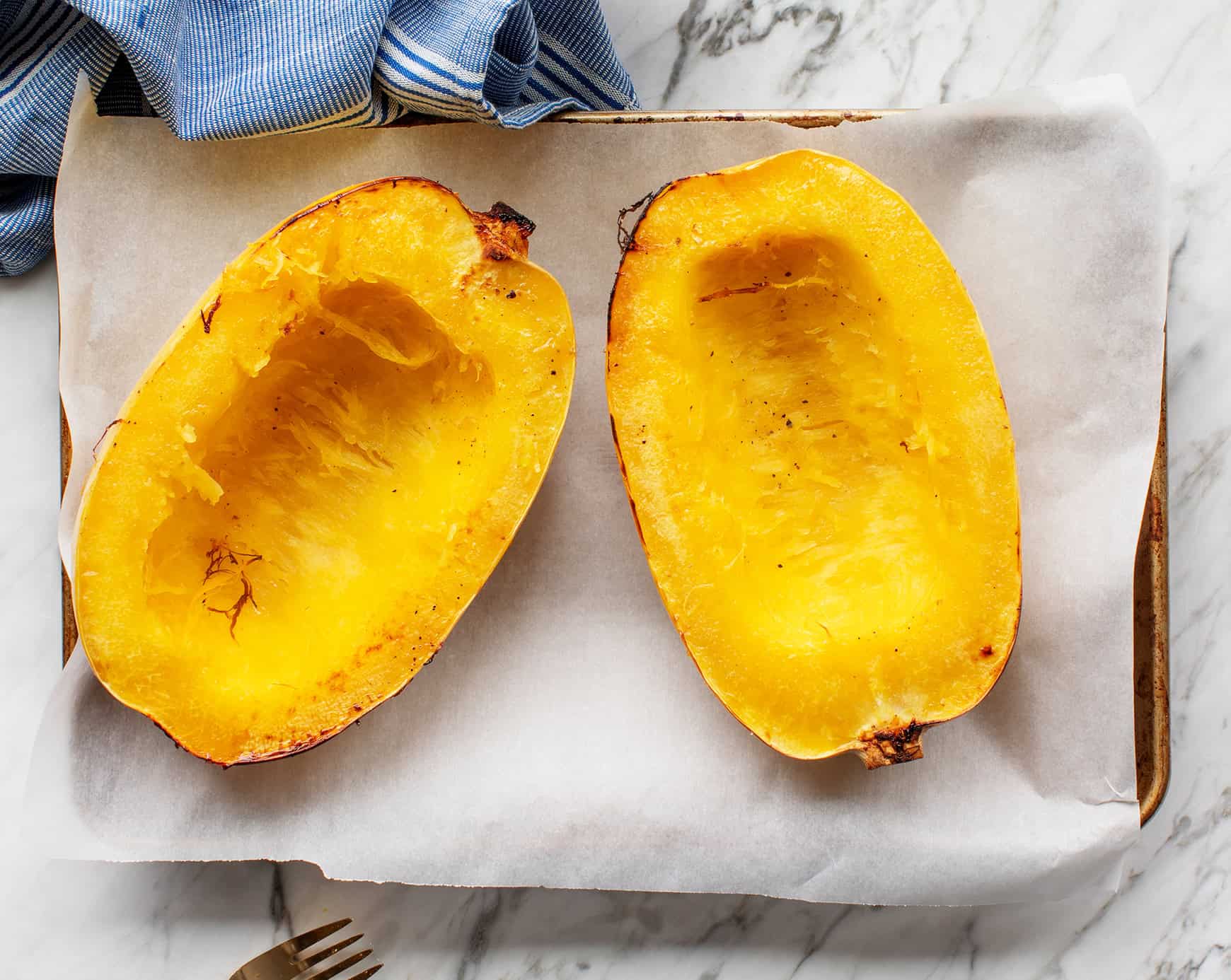spaghetti squash cooked on a baking sheet