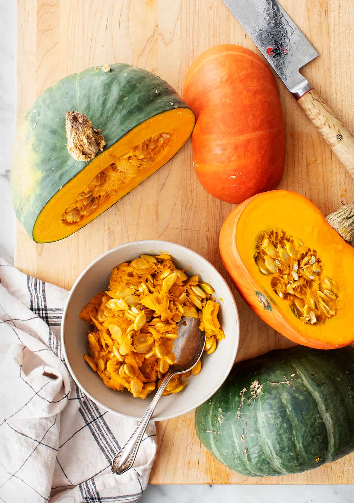 Halved kabocha squash on a cutting board