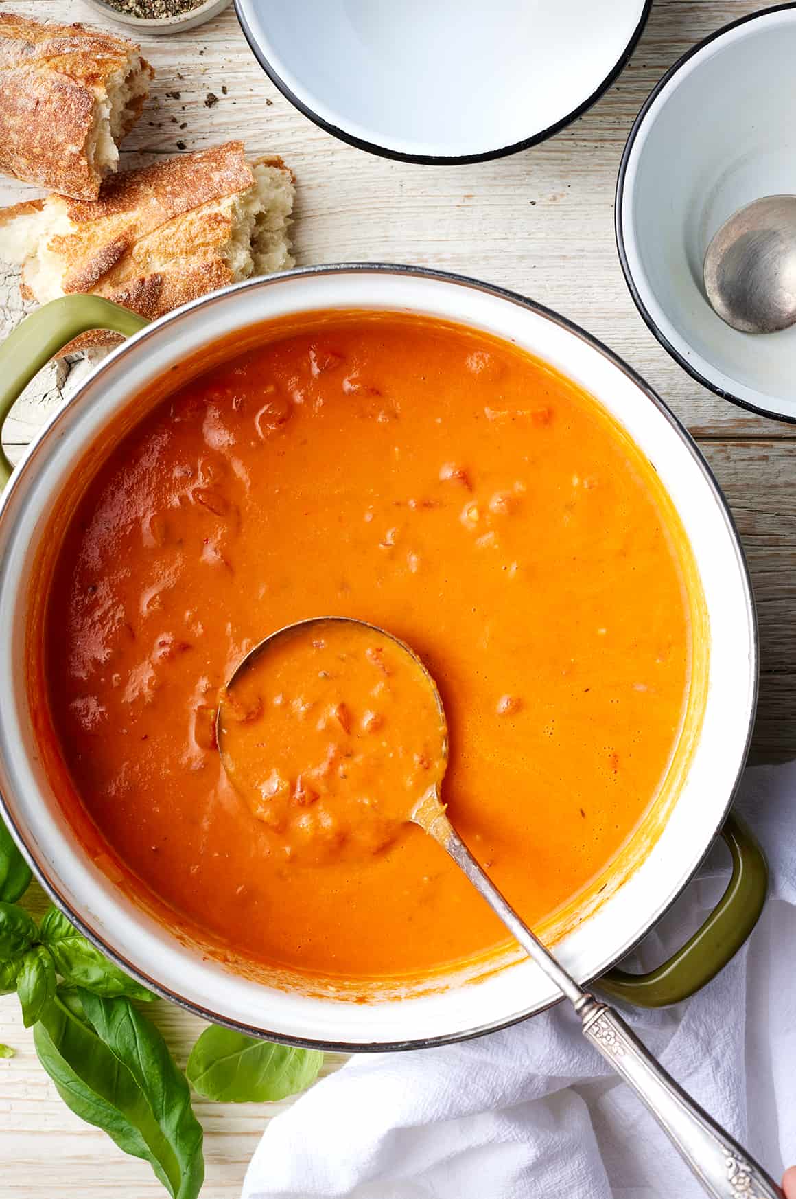 Pot of homemade tomato soup with silver ladle