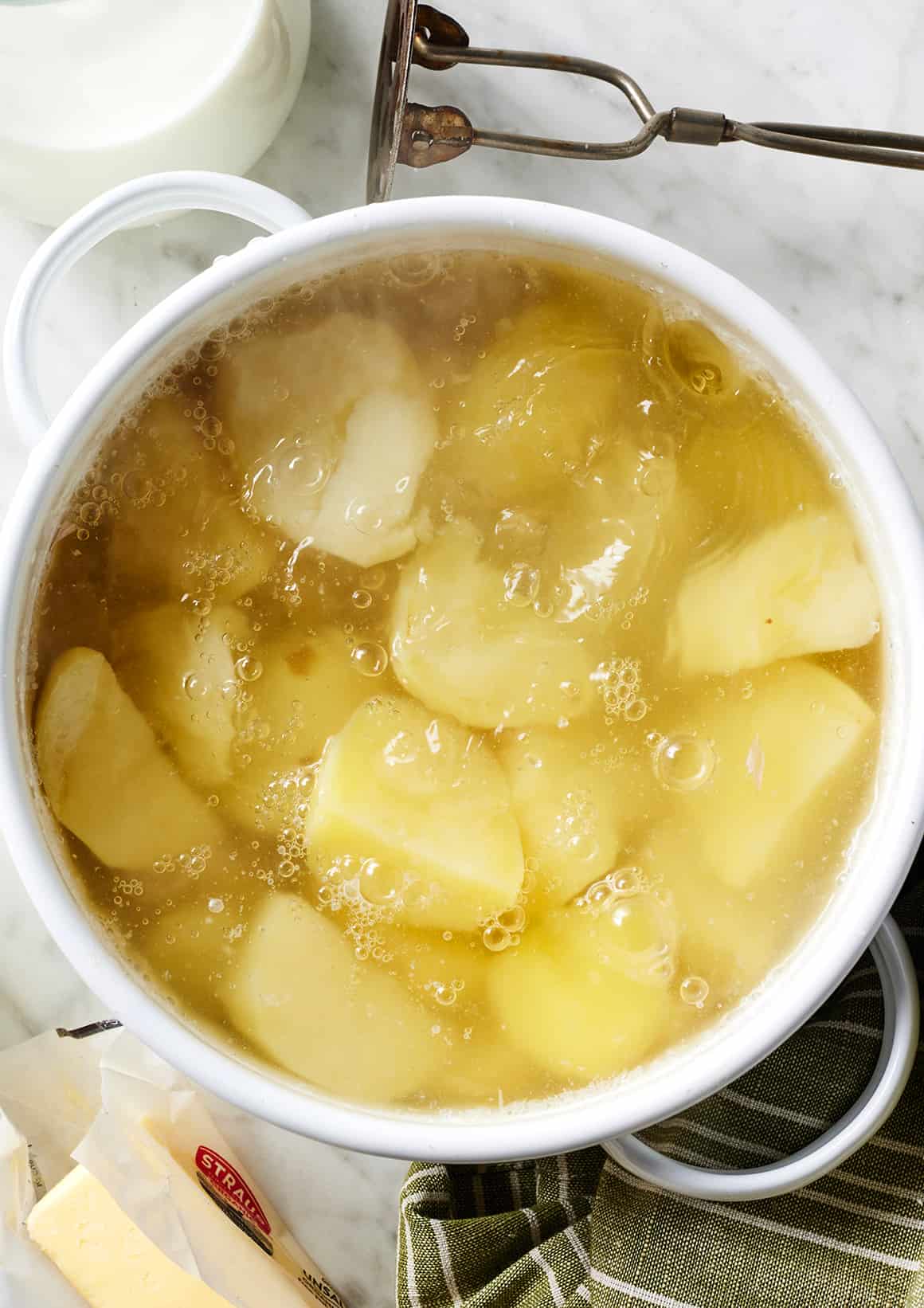 Potatoes boiling in pot with water