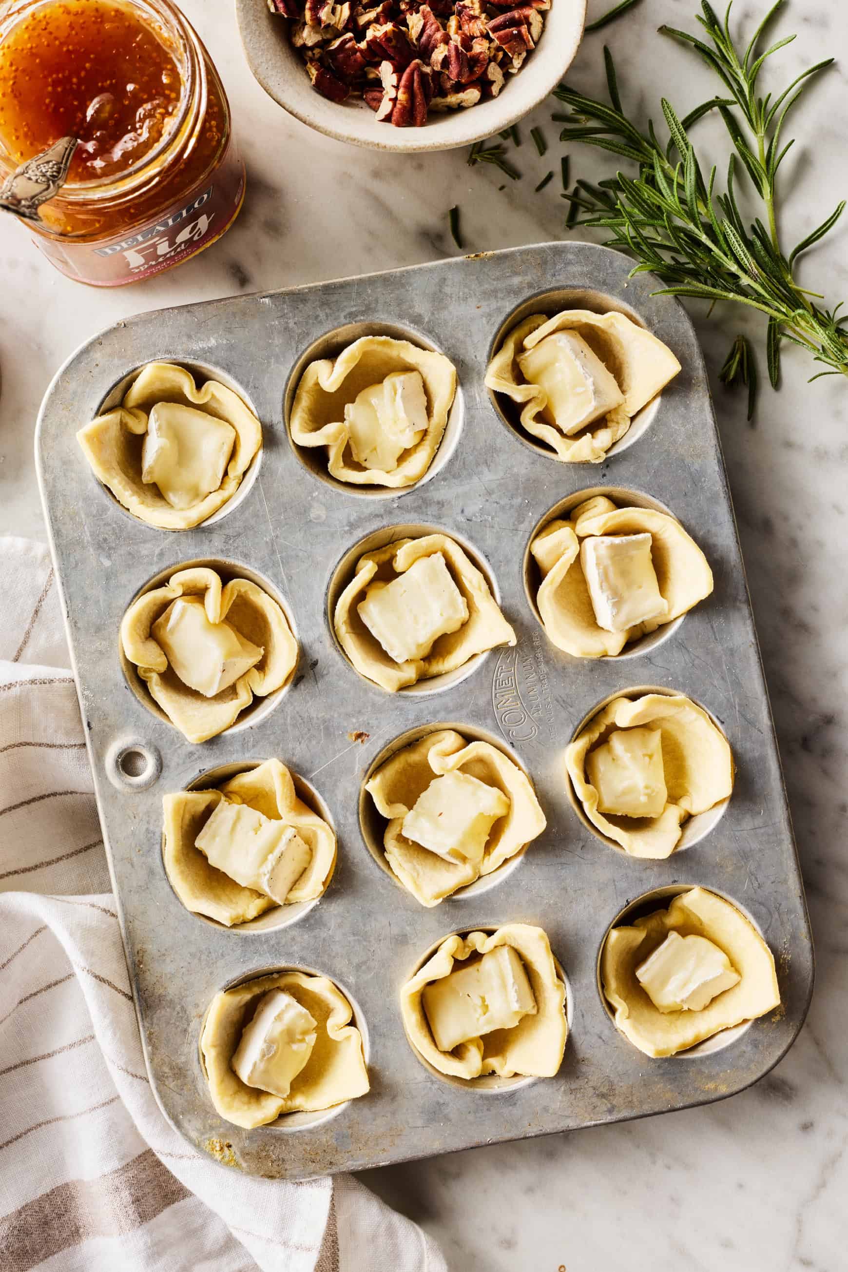 Mini muffin tin filled with puff pastry and cheese