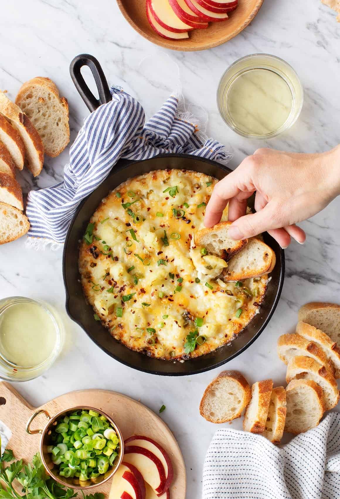 Cheesy baked cauliflower dip in skillet