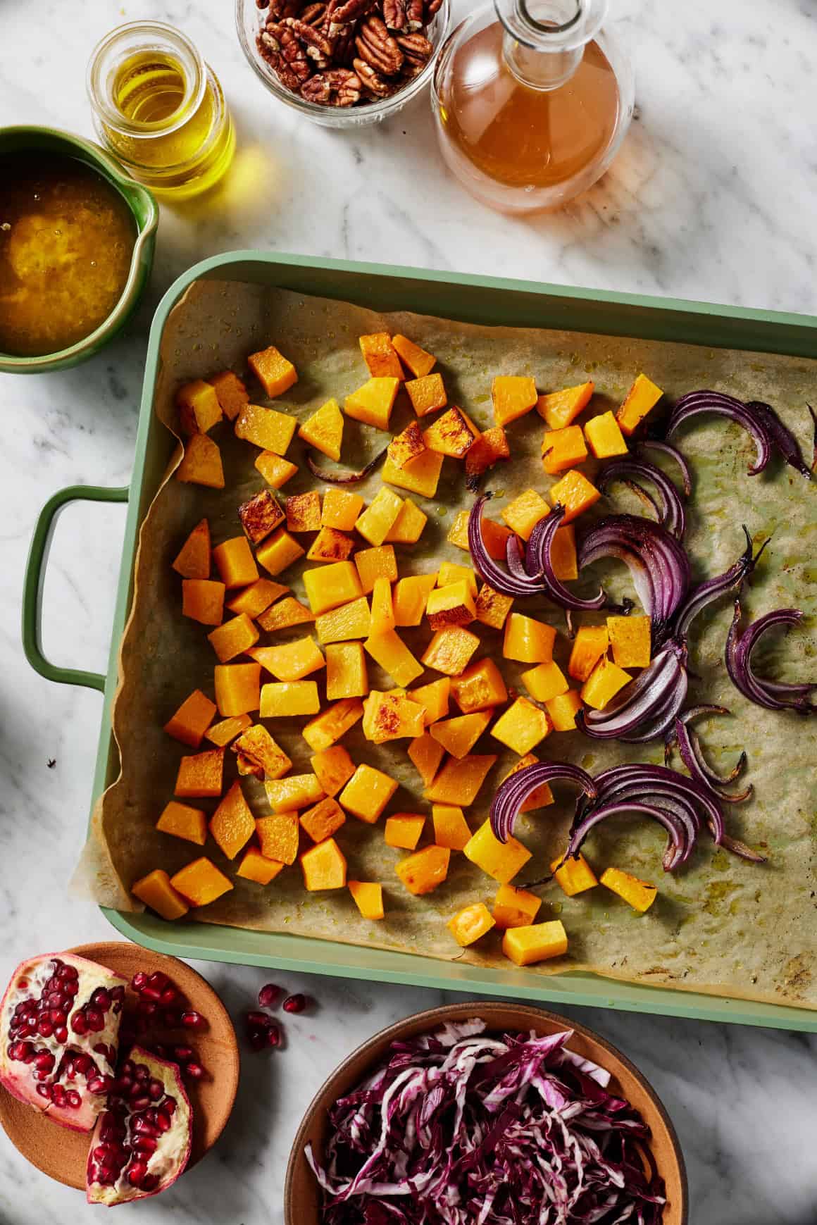 Roasted butternut squash and onions on baking sheet