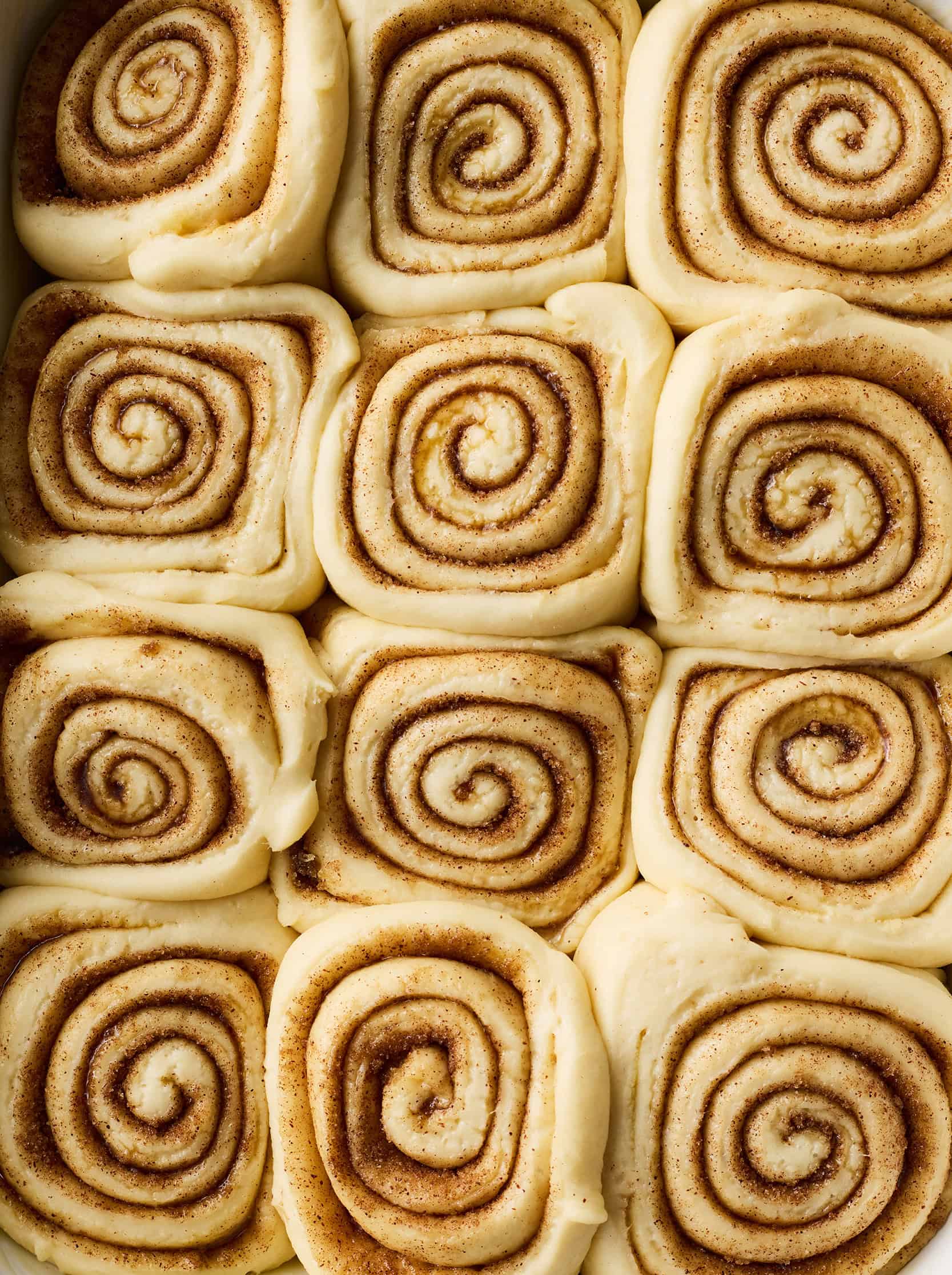 Cinnamon roll recipe after rising, but before baking - rolls tightly packed in baking dish