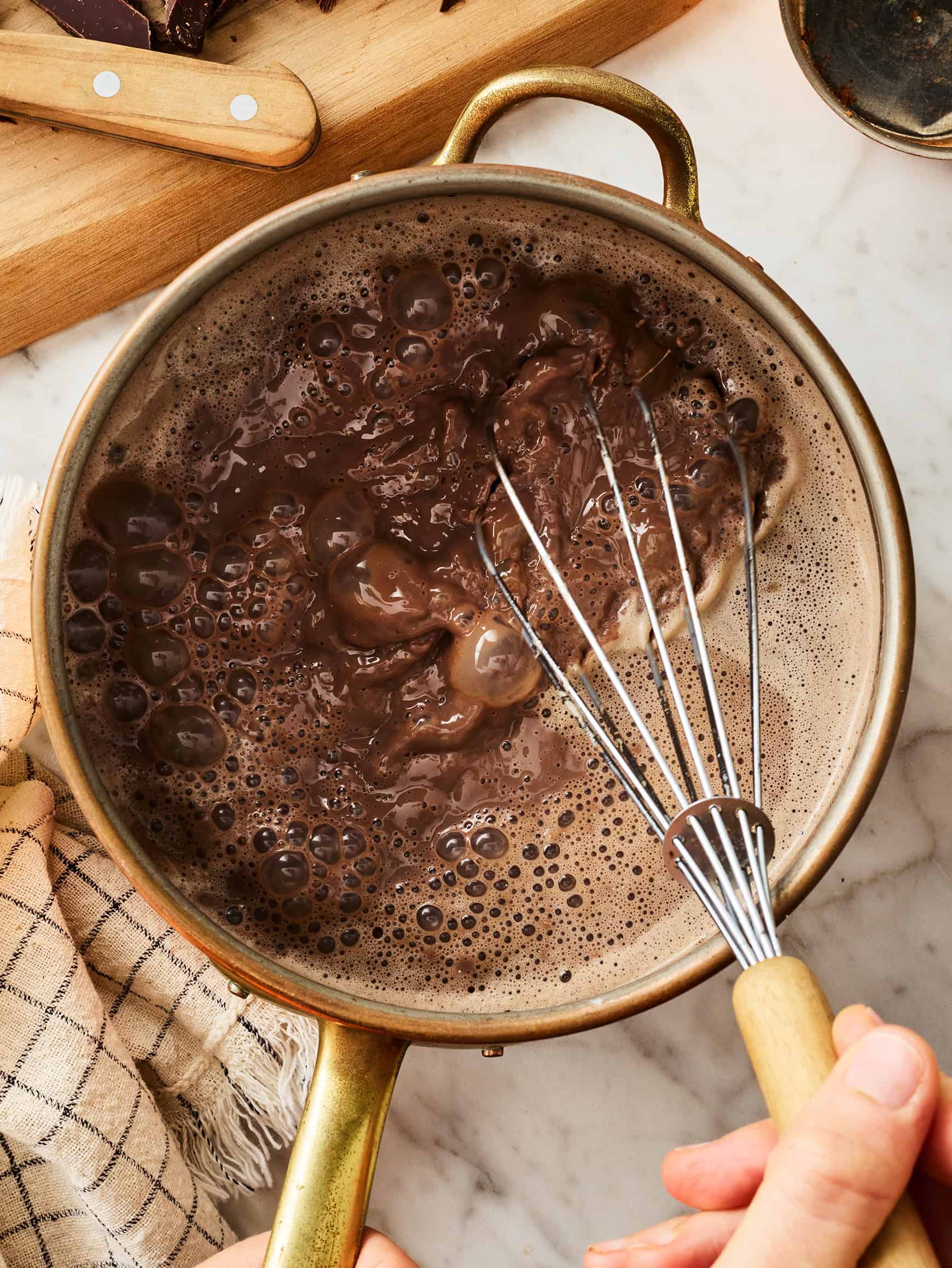 whisking hot chocolate in saucepan