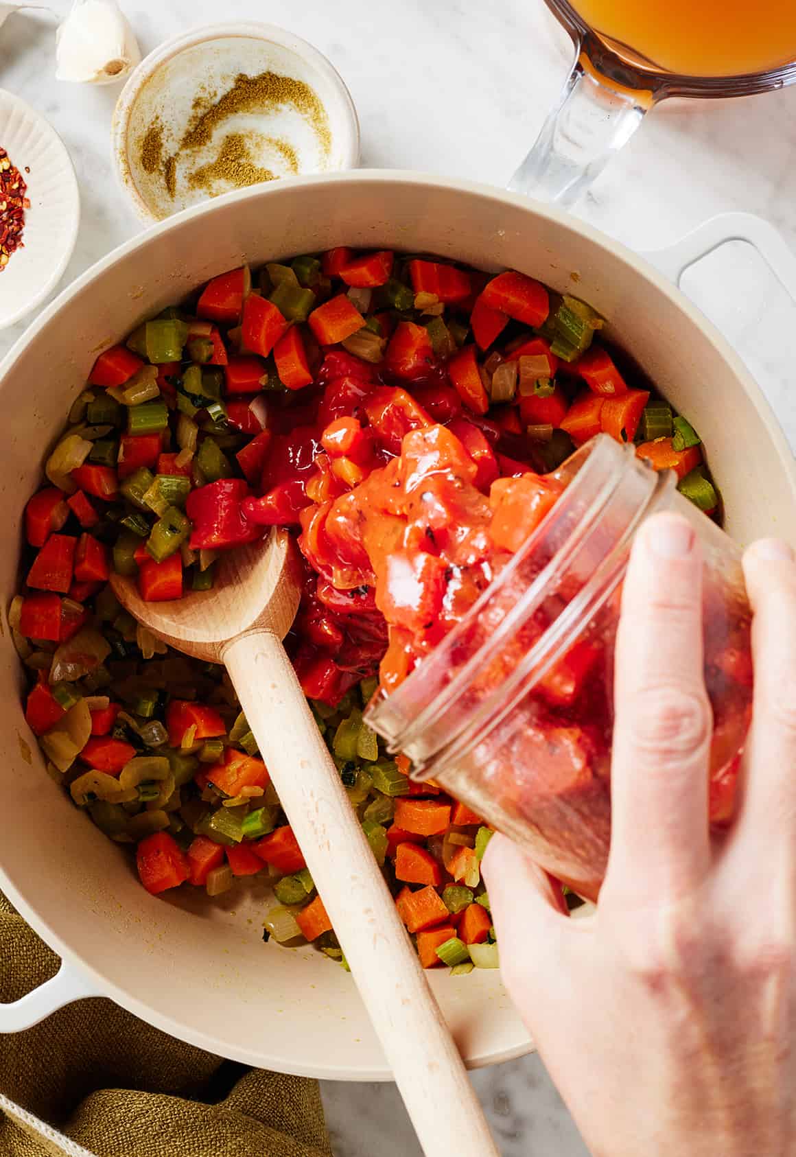 Adding diced tomatoes to pot