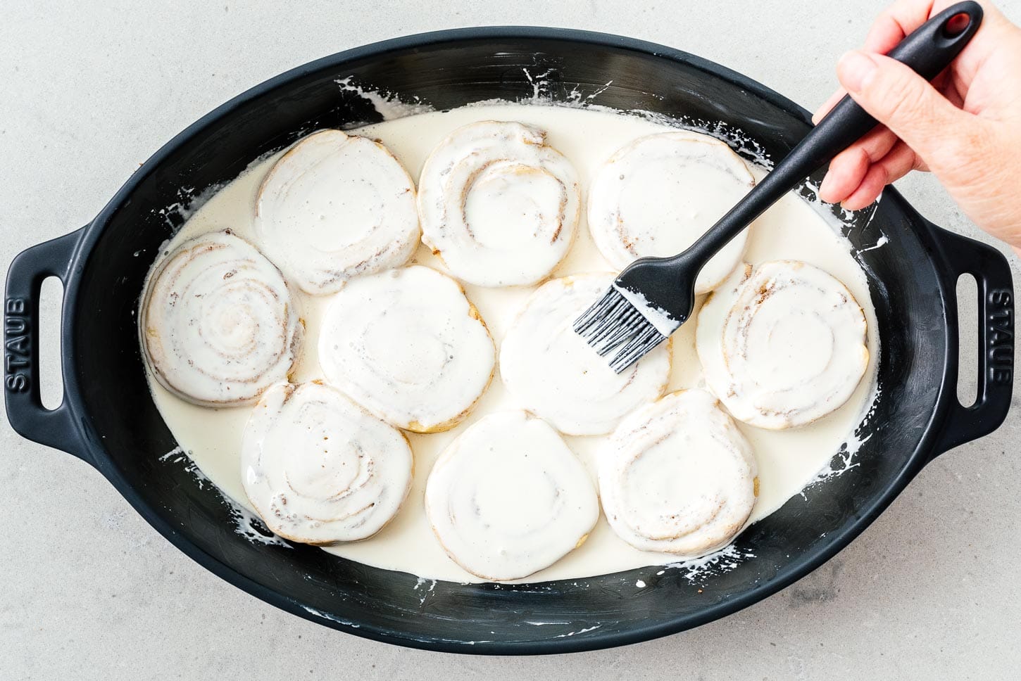 adding cream to tiktok cinnamon rolls | www.iamafoodblog.com