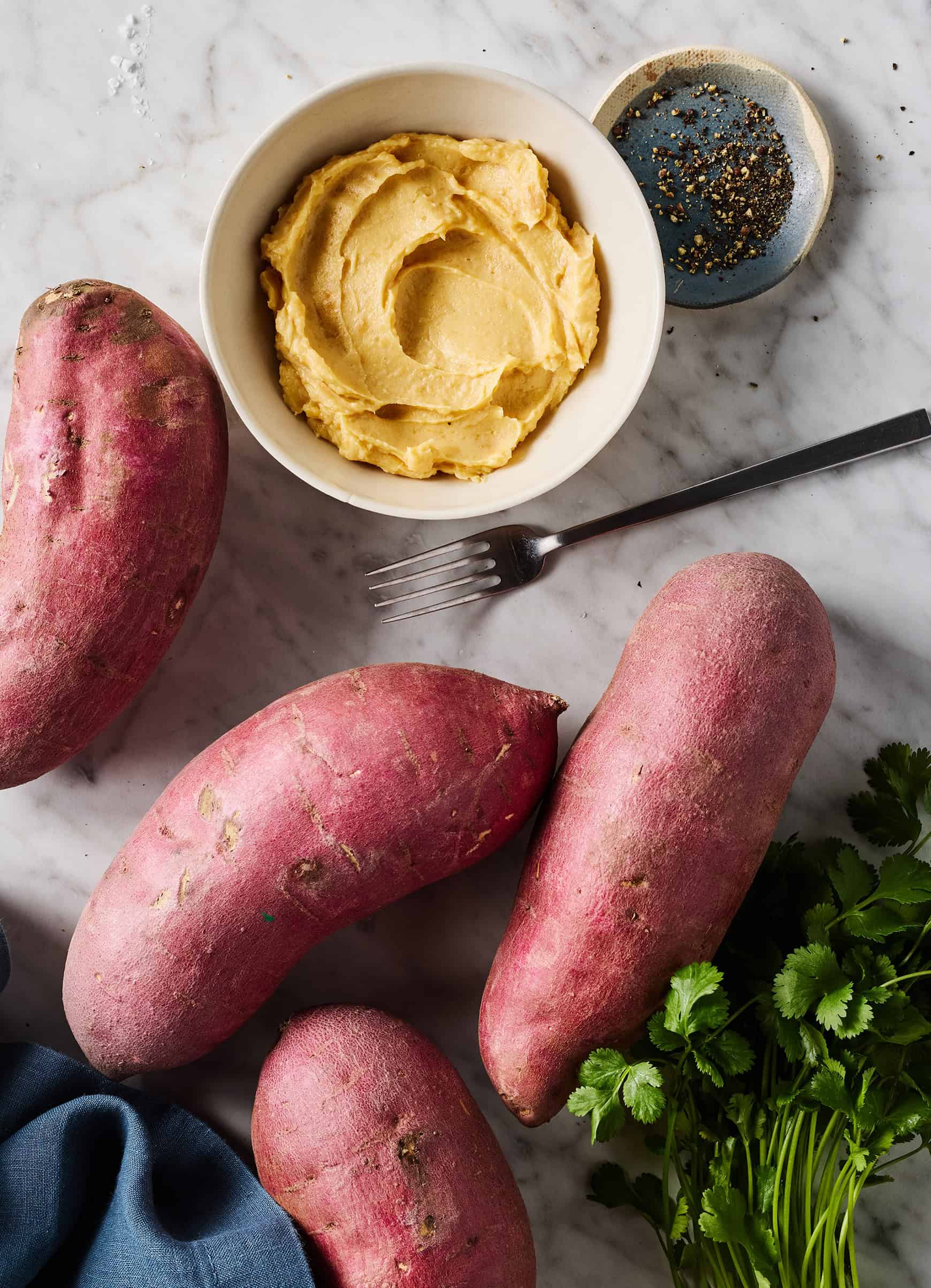 Whole Japanese sweet potatoes next to miso butter